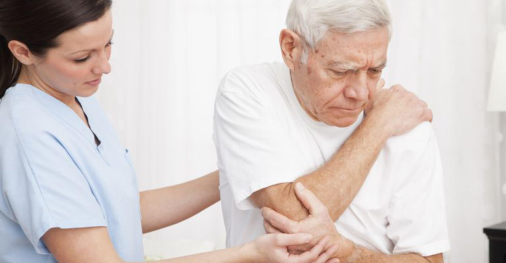 nurse comforting an old man who is ill