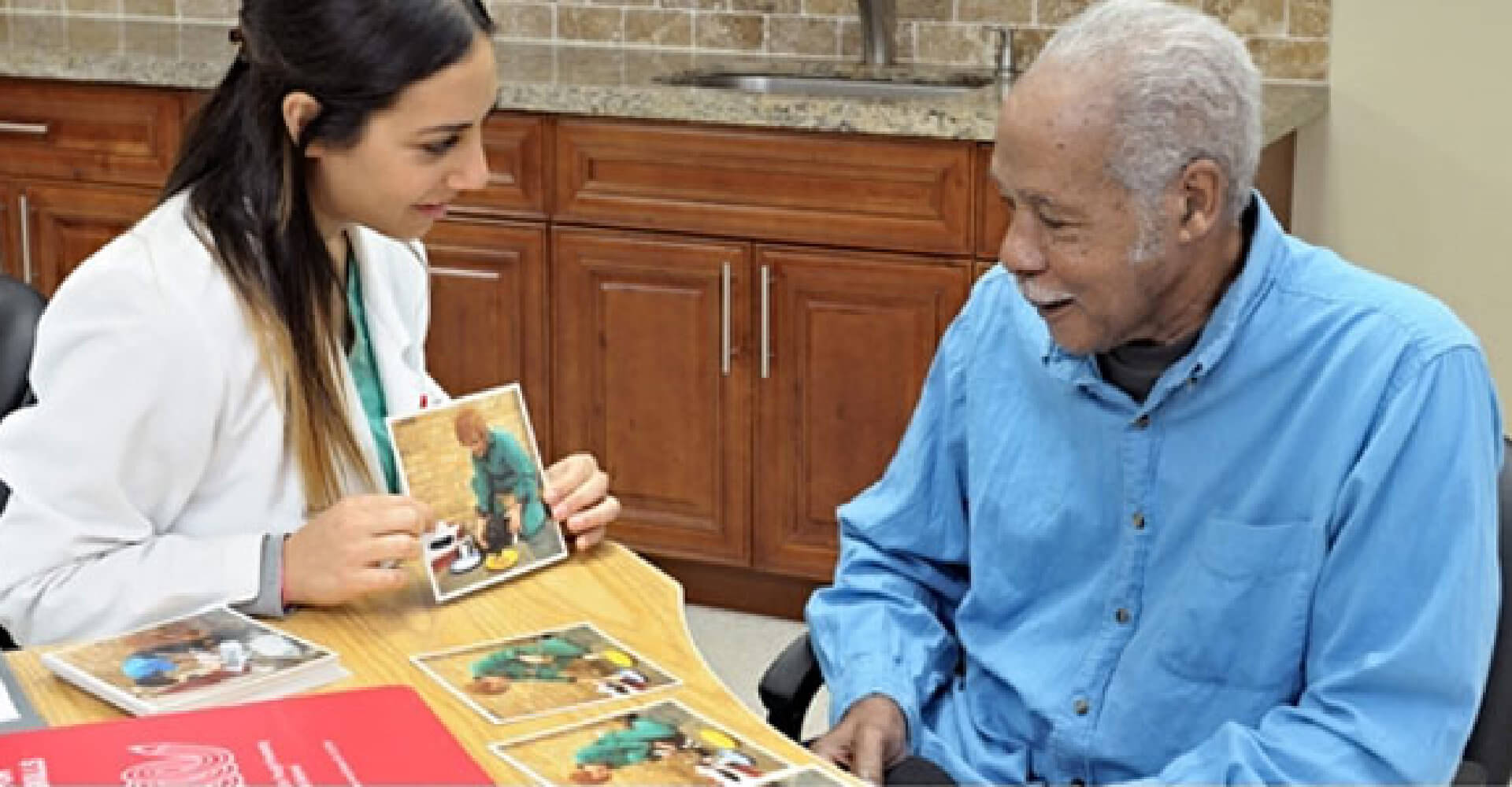 nurse showing picture to an old man